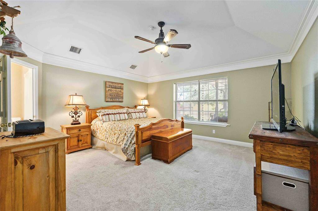 Primary Retreat offering vaulted ceiling with crown molding and plenty of space to add a sitting area.