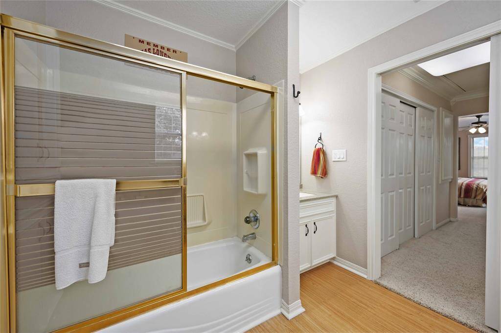This is a private bath upstairs attached to one of the secondary bedrooms. It offers a tub with shower, vanity and custom built in linen cabinet.