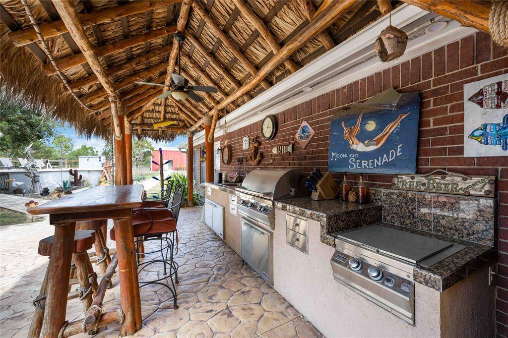 The outdoor kitchen offers built in gas appliances.