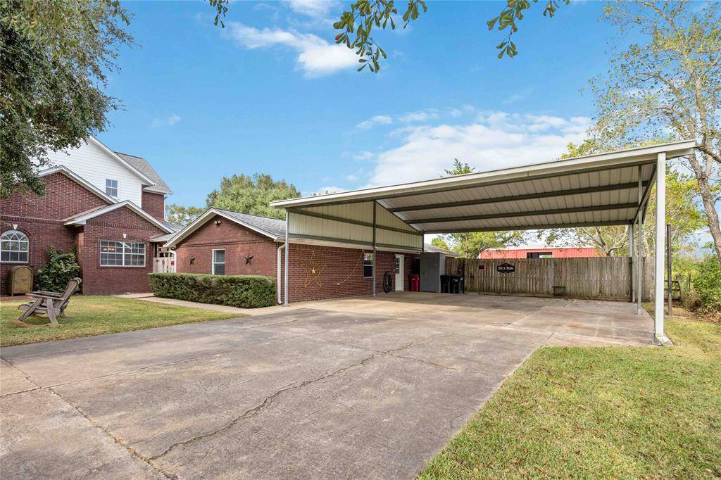The property is fully fenced. The 3 car carport offers a gate to access the full property by vehicle.