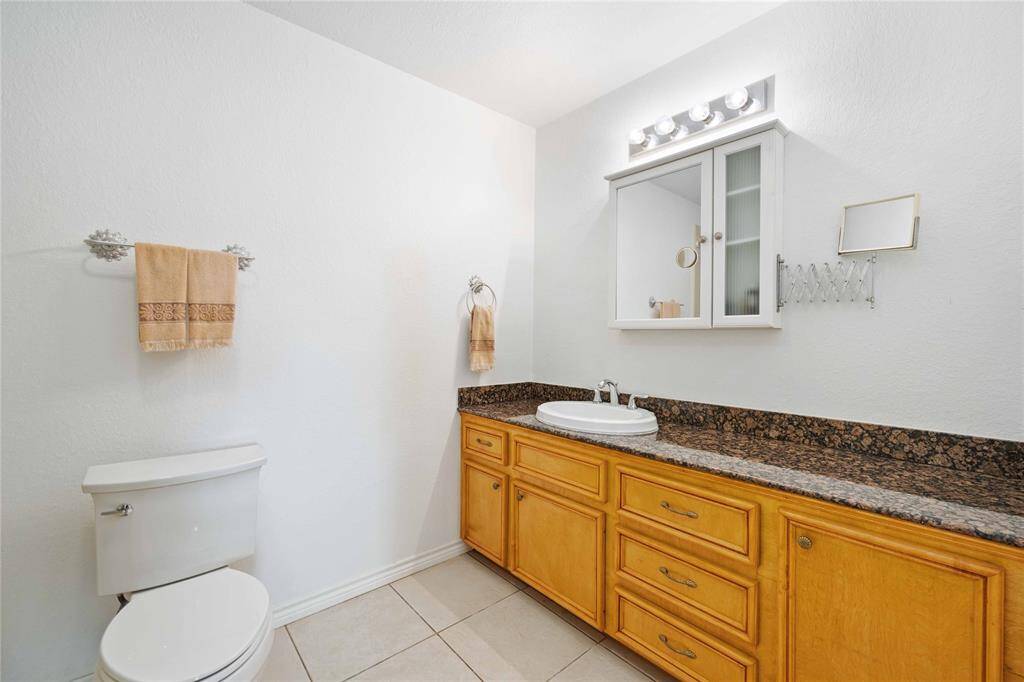 The guest house full bathroom offers an oversized shower and ample bathroom counter space.