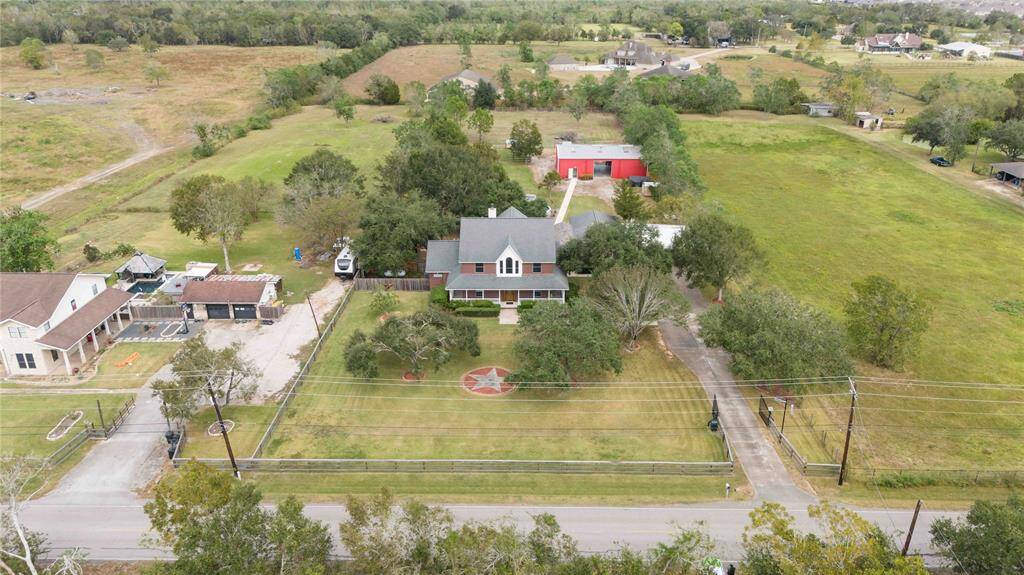 Welcome Home.  This 2.5 acre ranch is ready for a new owner.  Main house offers 3 bedrooms, 3.5 bathrooms, office, dinning, 3 car covered car port.  Guest house offers 1400 sq.ft, bedroom, bathroom, full kitchen and utility with extra large living room. The fully air conditioned barn has a game room/weight room - Shop space and room for automobiles. This home has it all.