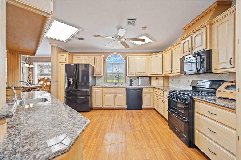 The main house kitchen over looks the breakfast and living rooms.  It's open concept is great for family togetherness.  Call today and host Christmas 2024 here!