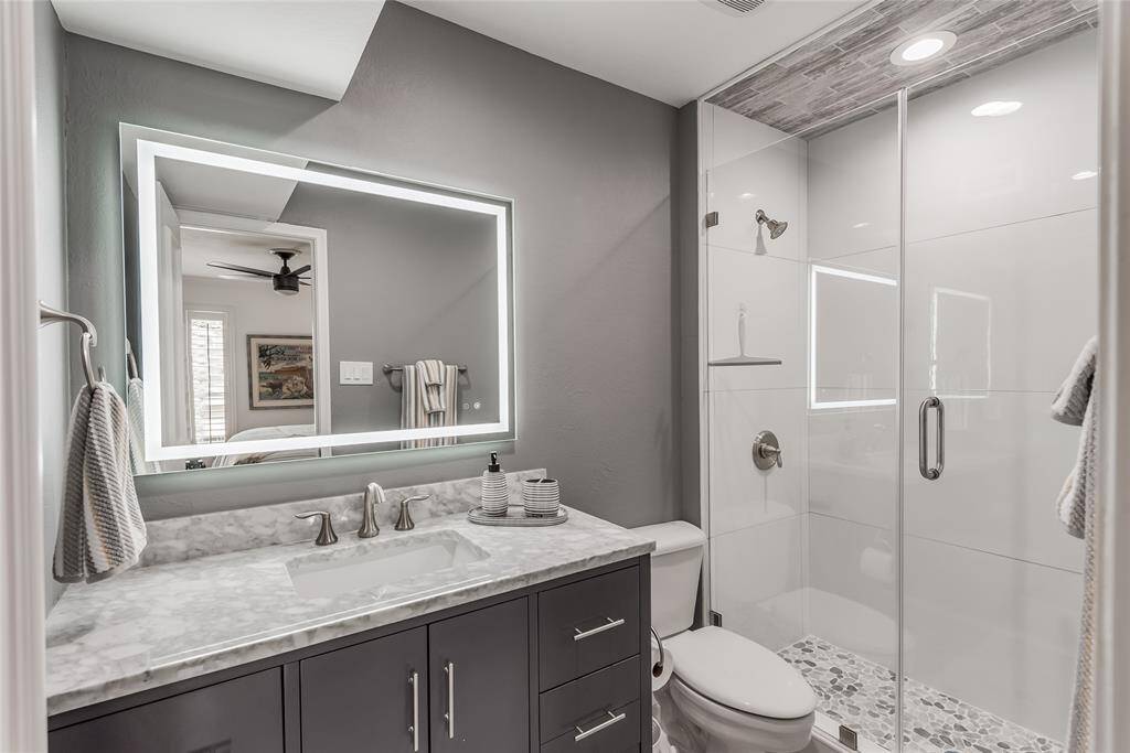 New vanity with marble top, electric mirror, new shower, fixtures and tile