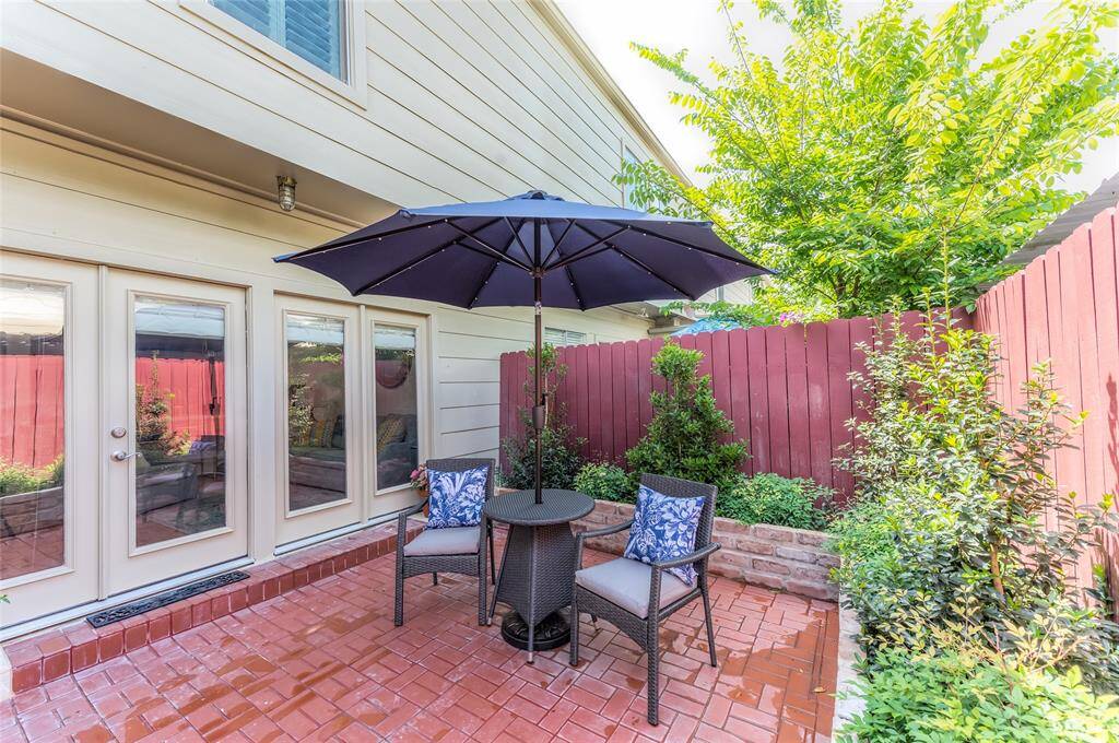 Brick paver patio with new shrubbery and outdoor furniture.  Umbrella can be turned on with lighting underneath.