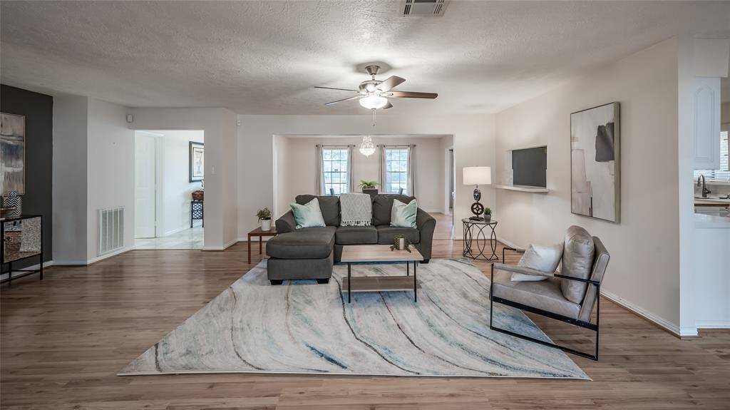 A special nook space beside the fireplace could serve as a bar area or place to house your media equipment with charcoal paint accent wall and lovely accents of marble on the hearth.