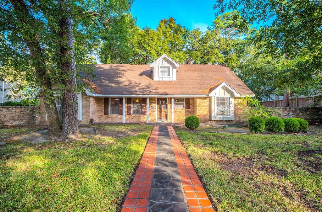 This 2 story brick home featuring a gabled roof, a welcoming pathway leading to the front door, flanked by mature trees and landscaped shrubbery. Located on a cul-de-sac on oversized lot, it offers direct access to Terry Hershey park through a gate at the end of the street.