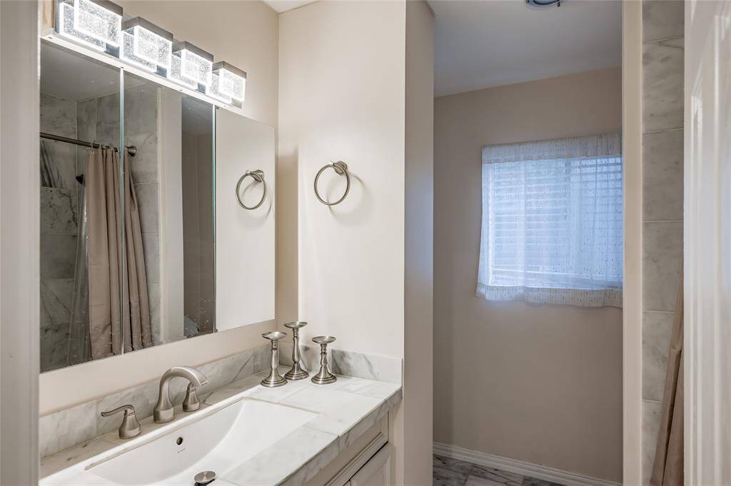 Another angle of secondary bedroom down showcasing the natural light and closet space.