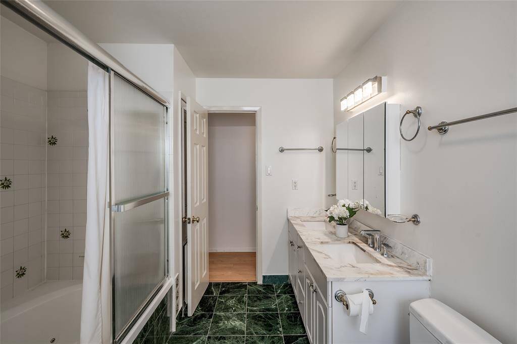 The large bathroom upstairs offers marble counters, marble flooring, deep soaker tub/shower and loads of space.