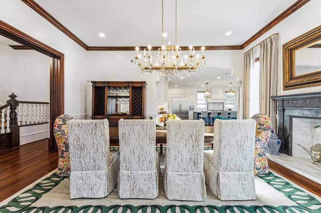 Formal Dining: Refinished original trim, refinished/operable original pocket doors/hardware, original metal mock fire place, and Schonbek crystal chandelier.