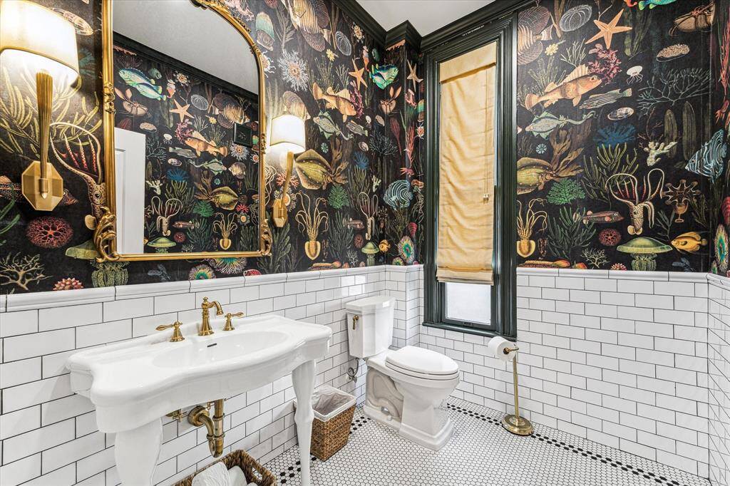 Half Bath located next to the Butler stairs. Romanian eco friendly wallpaper, custom window covering, Toto toile, and high end finishes.