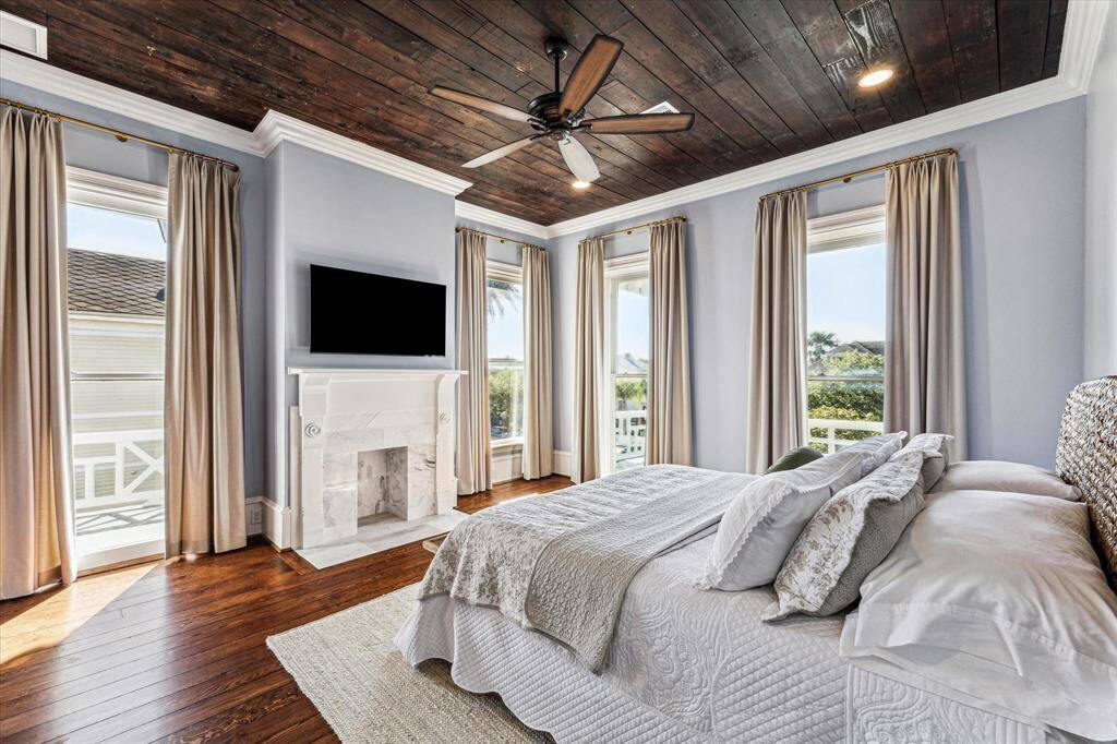 Master Bedroom: Mock fireplace, refinished original ceiling, and custom thermal panels w/French brass rods.