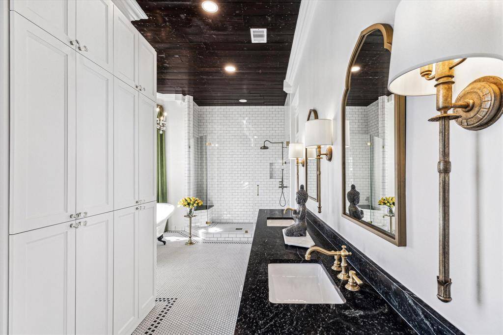 Master Bathroom: Dble sinks, antique brass hardware/ fixtures, custom cabinets, claw tub, walk in shower w/Rohl shower fixtures, refinished ceiling.