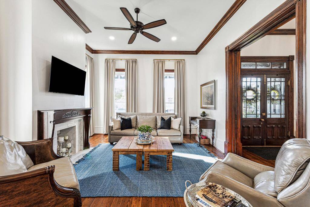Parlor 1: Antique mock fireplace mantel, refinished original trim and original operable pocket doors, custom thermal panels with French brass rods.