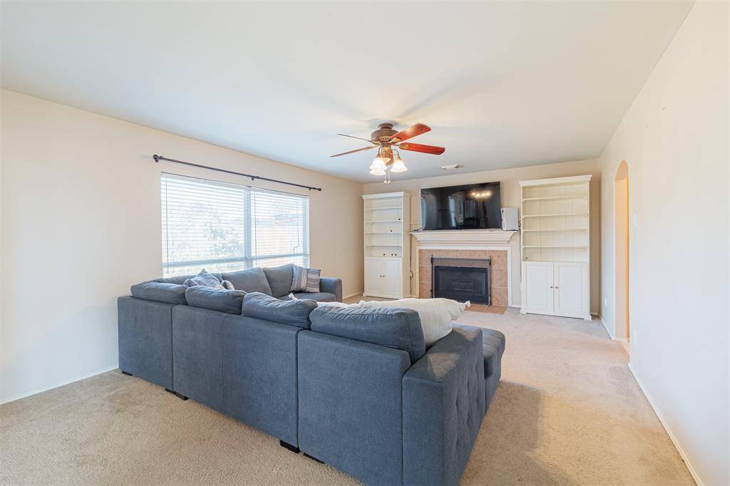 This spacious family room is a wonderful space to visit with friends and family or enjoy quiet evenings in. This space features a romantic gas-log fireplace with a rich wood mantle and tile surround.