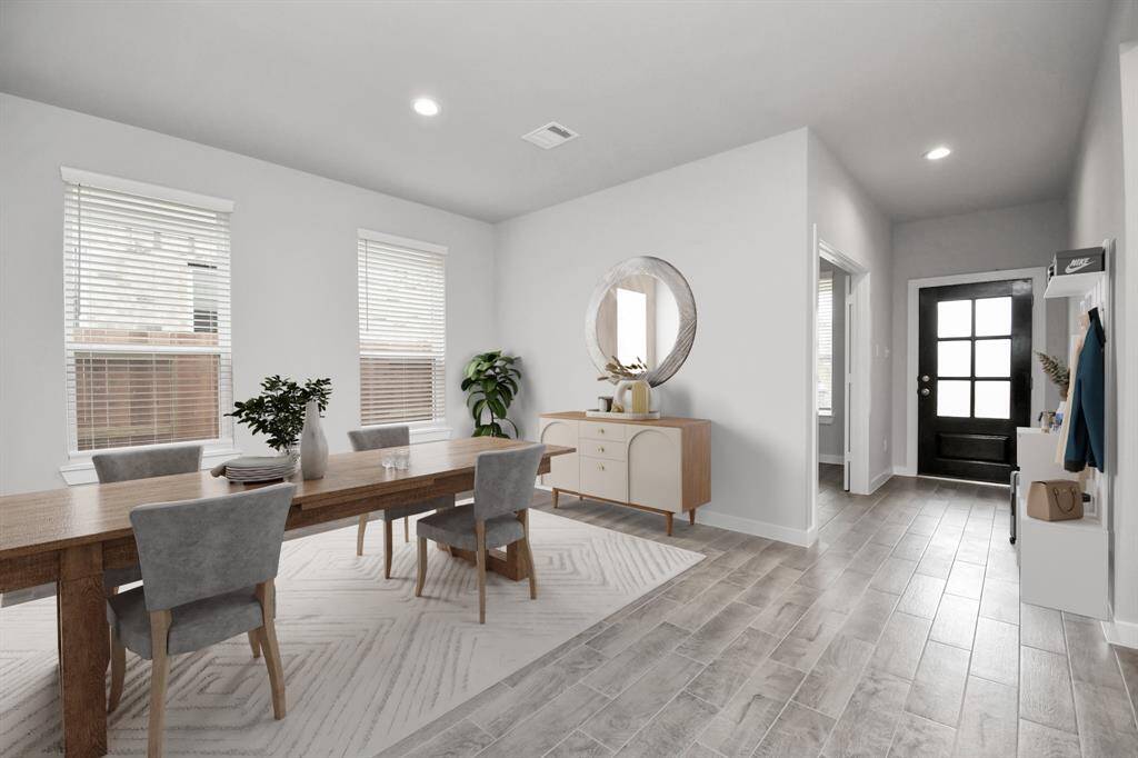 Craft enduring memories with loved ones around the table in this roomy dining area. It boasts stylish flooring, personalized paint, and is conveniently situated next to the family room and kitchen, fostering an open and inclusive ambiance.