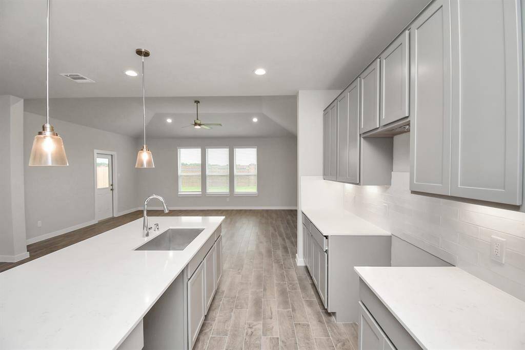 Discover another perspective of this stunning kitchen, generously appointed with an abundance of counter space