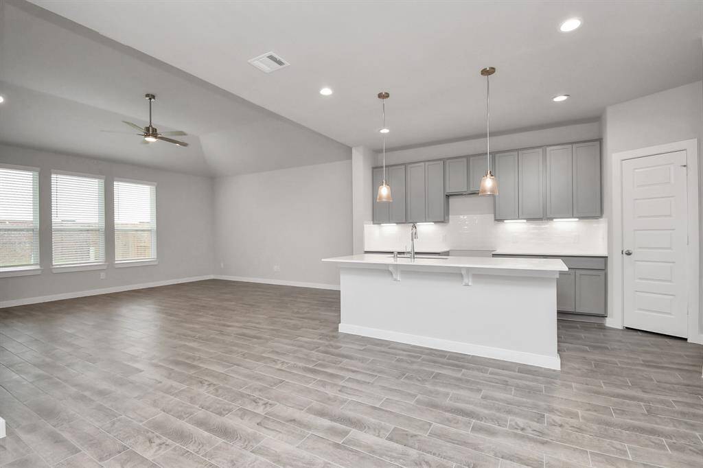 All of this overlooks your expansive family room, creating a perfect space for culinary delights and family gatherings.