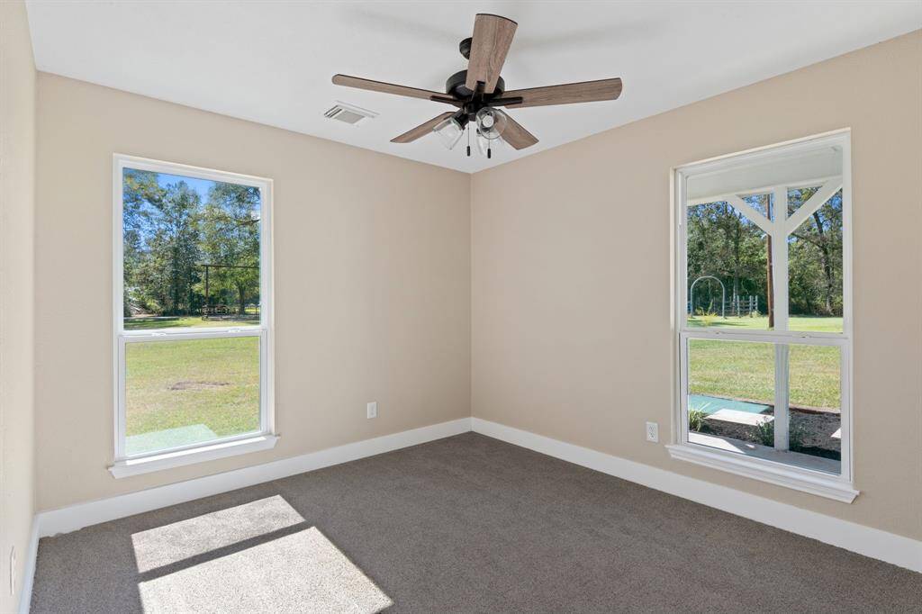 Secondary bedroom features large windows and plush brand new carpet.