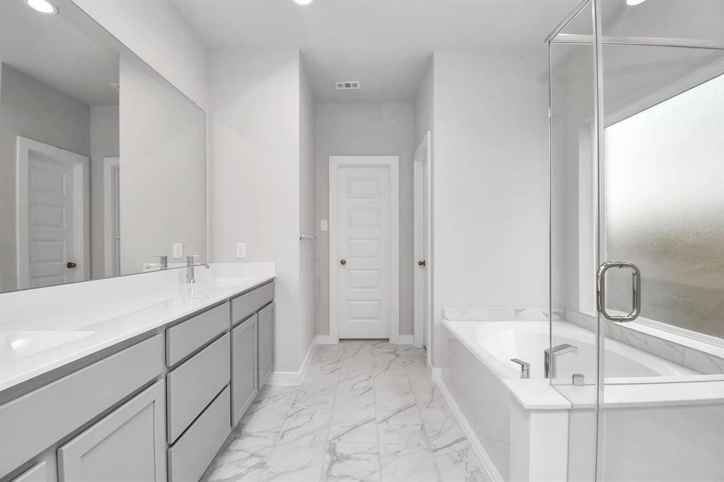 Experience a spa-like escape right in the heart of your primary bathroom.