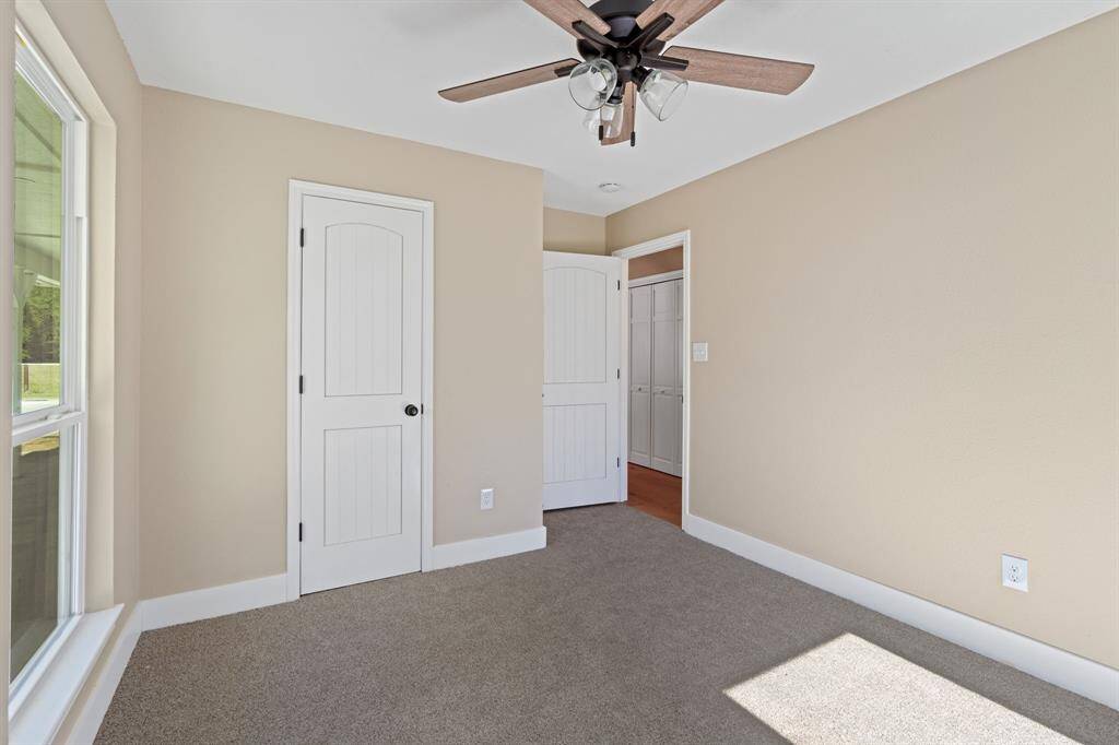 Secondary bedroom features large windows and plush brand new carpet.