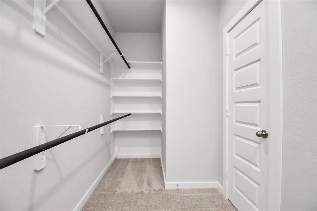 Walk in Closet with built in shelves.