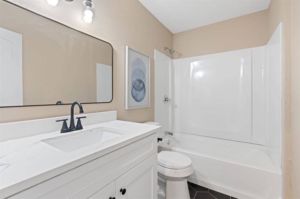 Secondary bathroom features atub/shower combo and long vanitywith plenty of counter space.