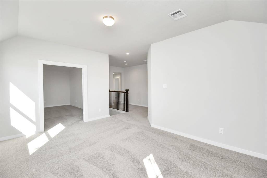 Come upstairs and relish a day of relaxation in this loft area! Ideal as anadditional living space or game room, it boasts plush carpeting, high ceilings,custom paint, and windows that flood the area with abundant natural light.