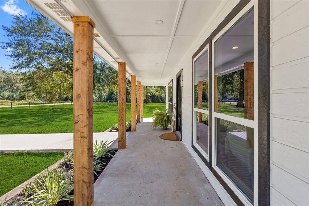 Approaching the front door you will see the covered front porch and lovely landscaping.
