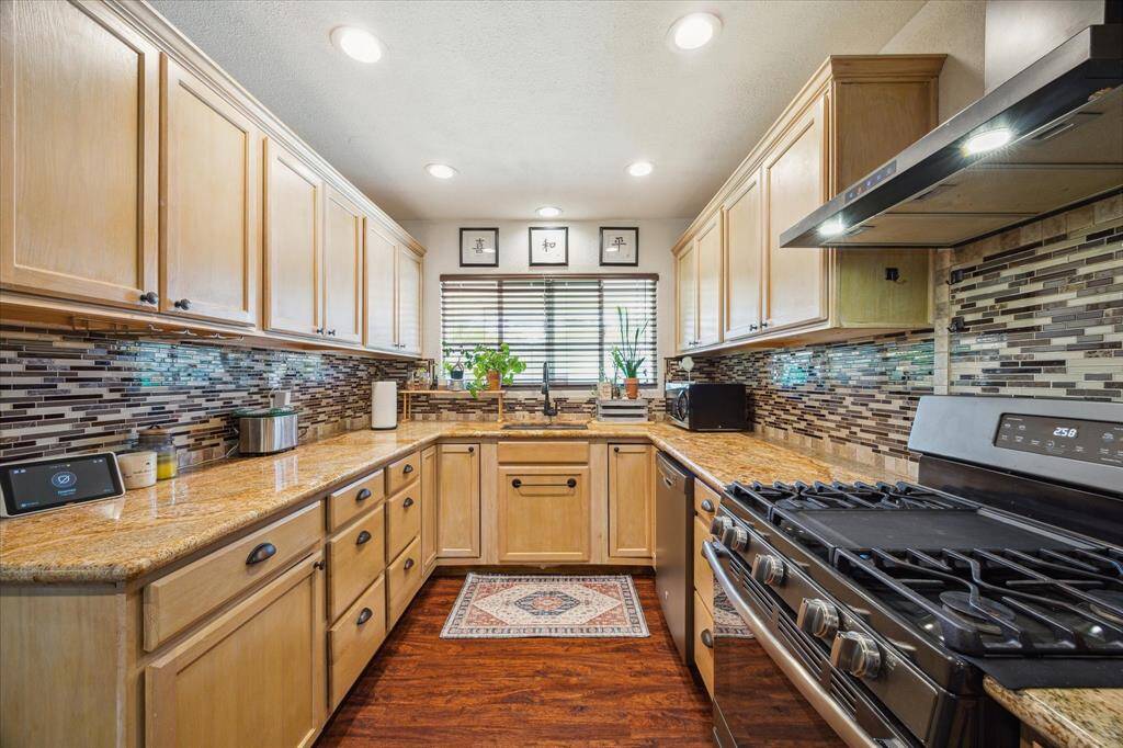 Fully remodeled kitchen with gas stove, vinyl flooring and granite counter tops. Refrigerator conveys!