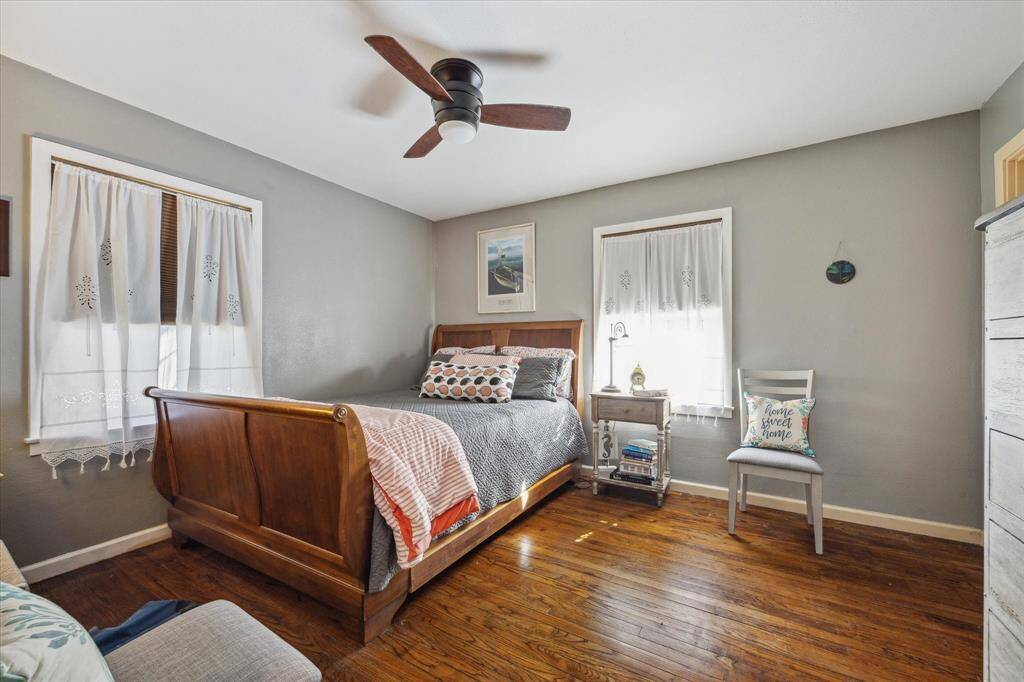 Primary bedroom with wood flooring and lots of natural light!