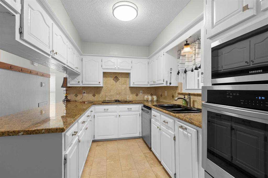 The kitchen has nice updates with granite counters and updated appliances. The pretty tile backsplash offers a nice modern look as well.