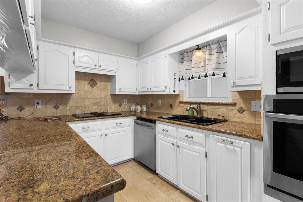 A more up close view of the kitchen showing the pretty white, painted cabinets.