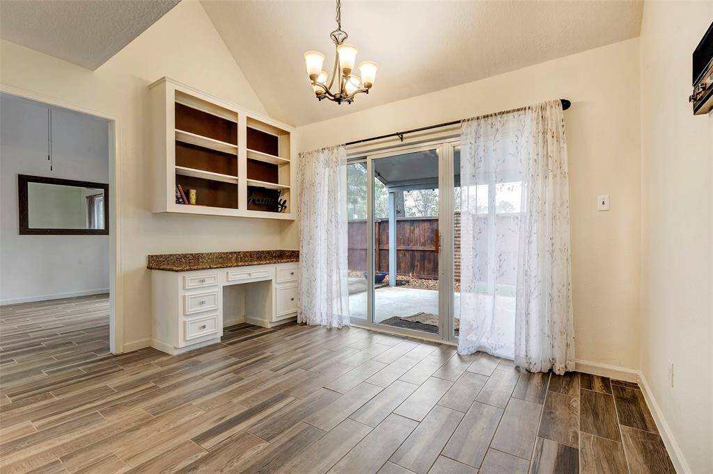 The breakfast area has plenty of room for a large table and the desk is a great place to keep things organized with decorative shelves. The sliding doors are recent just like all the windows.