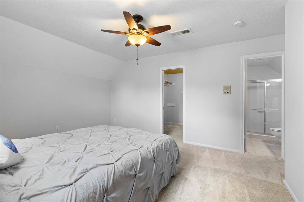 This is the upstairs primary bedroom showing doors to the large closet and ensuite bath for this room