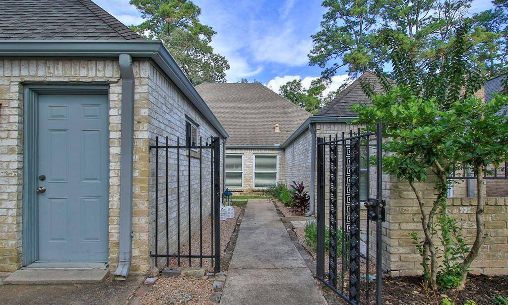 Enter the pretty front gate into the courtyard. The home is 4 sides brick for easy care.
