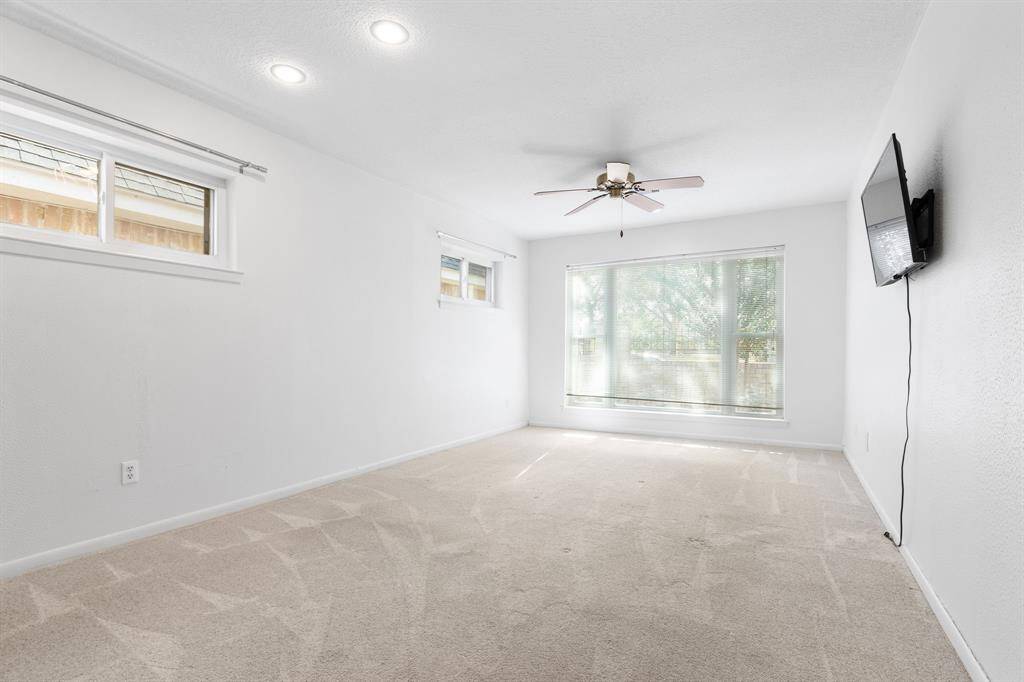 The third bedroom has the only carpet in the home. There's a picture window looking out to the front courtyard. These bedrooms are all split, making great privacy