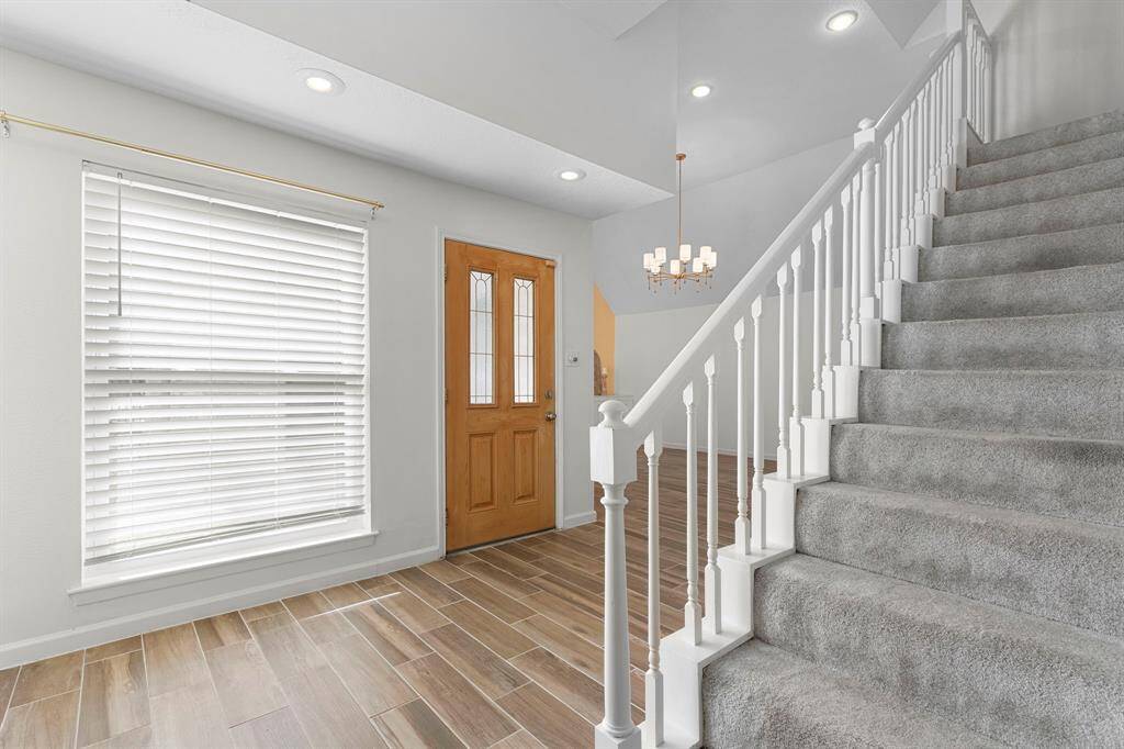 The front door has a large window next to it for great lighting. You can go directly to the family room or the other way to the kitchen if you need to drop off groceries