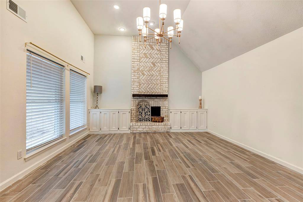 This pretty focal point brick fireplace has had a fresh coat of paint added to the wall around it. A pretty light grey gives it a nice updated look.
