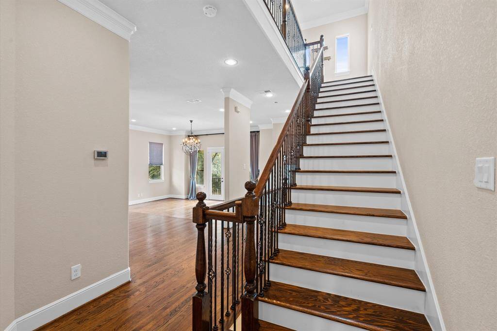 Gleaming hardwood stairs going up to the primary level.