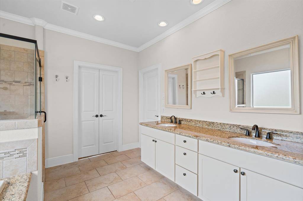 Grand double doors bring you into the primary bath suite. Notice double sinks!