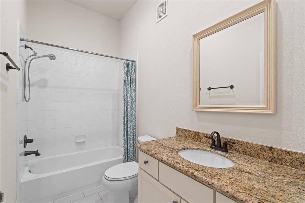 This bathroom has nice finishes and plenty of storage for guests!