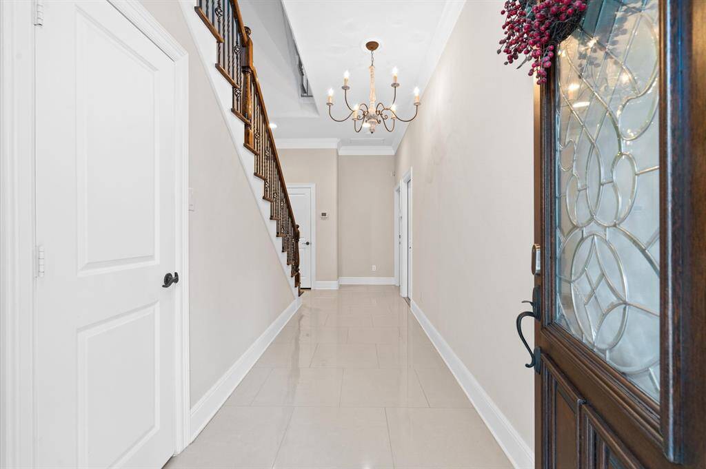 Welcome home! Gorgeous entry, behind the first door is an epoxy floored garage, the large patio. The next door has a generous bedroom and bathroom. This floor also has nice storage closets!