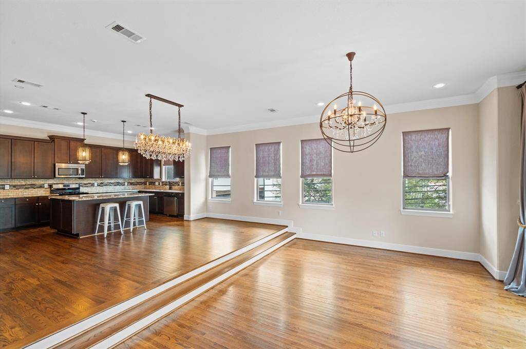 Large living room and dining room for large gatherings! Notice the high end custom Belgian linen shades and drapery.