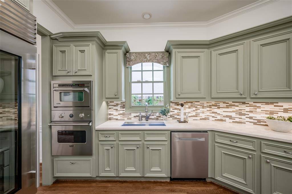 This gourmet kitchen features a sleek Sub-Zero glass-front refrigerator and a high-end Viking steam and convection oven for exceptional cooking.