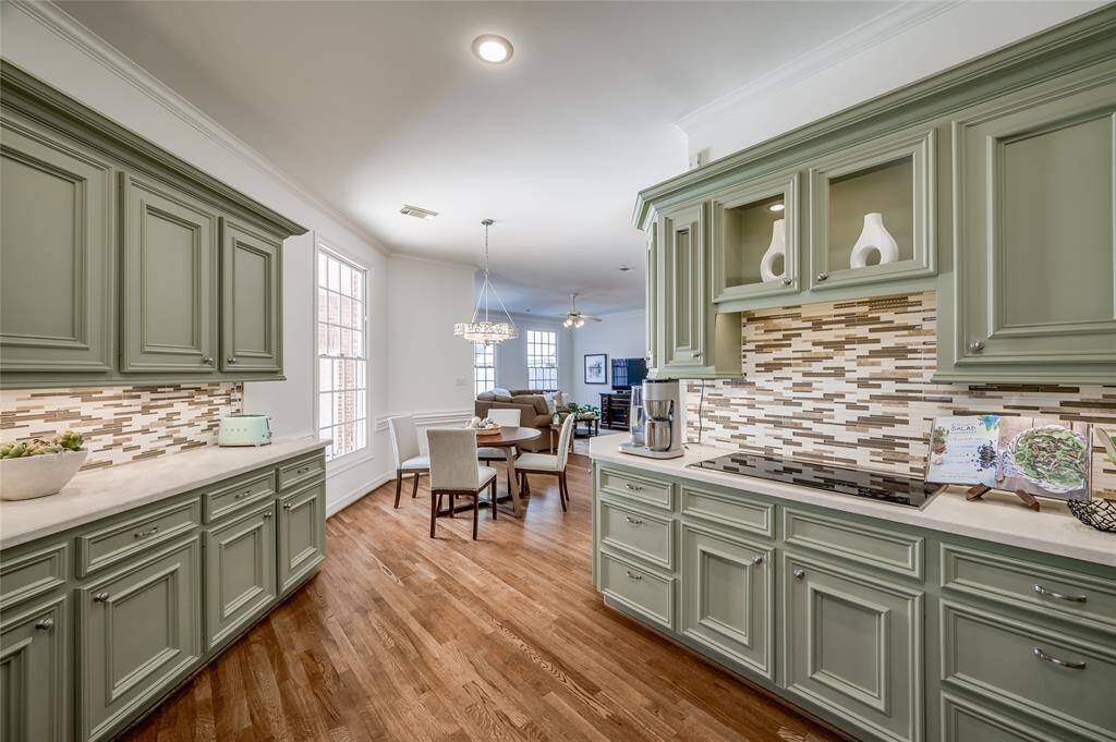 The heart of the home,  this open kitchen, seamlessly connects to the breakfast and family rooms.