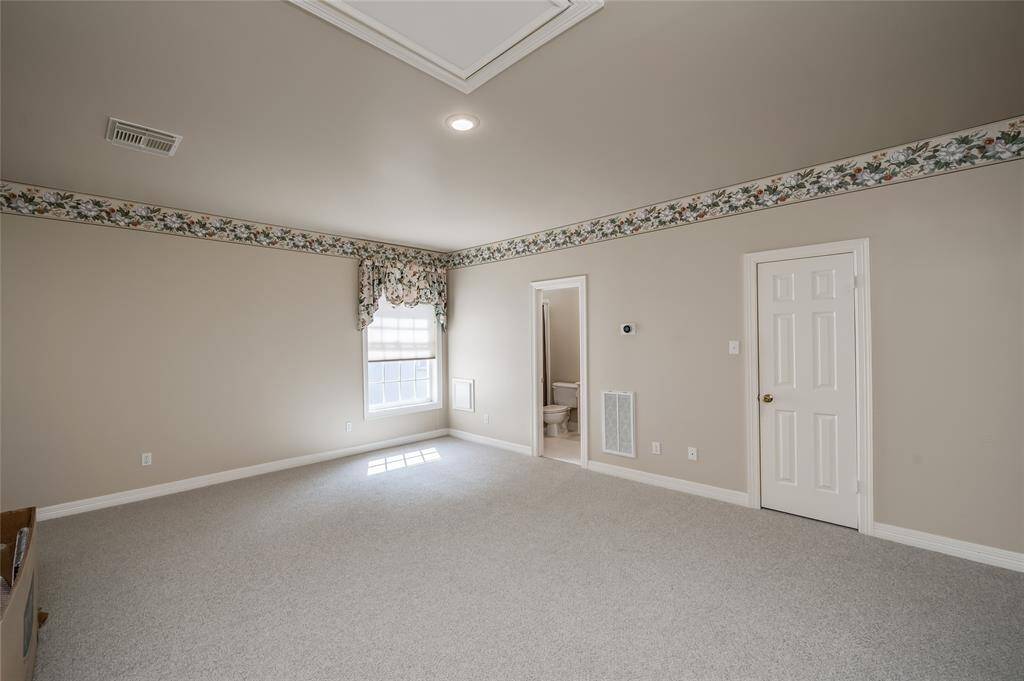 Versatile guest suite with a full bath and tub/shower, two walk-in closets, and fresh carpeting—also ideal for a gym, game room, or workspace.
