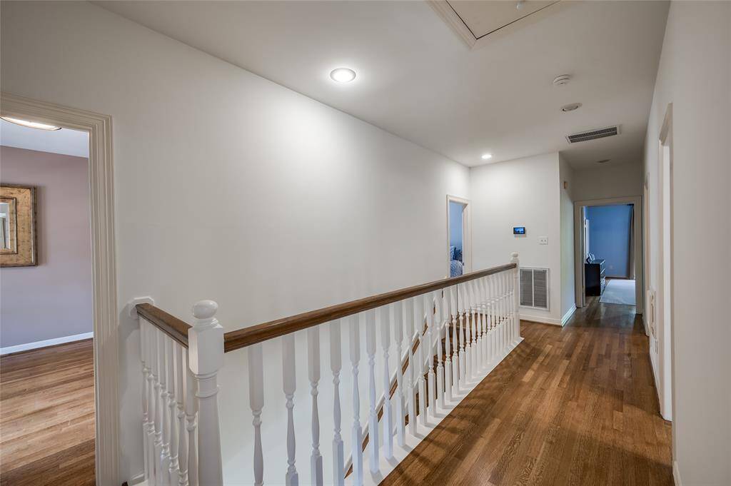 Discover the upstairs retreat featuring a spacious primary suite, three additional bedrooms, and a large laundry room.