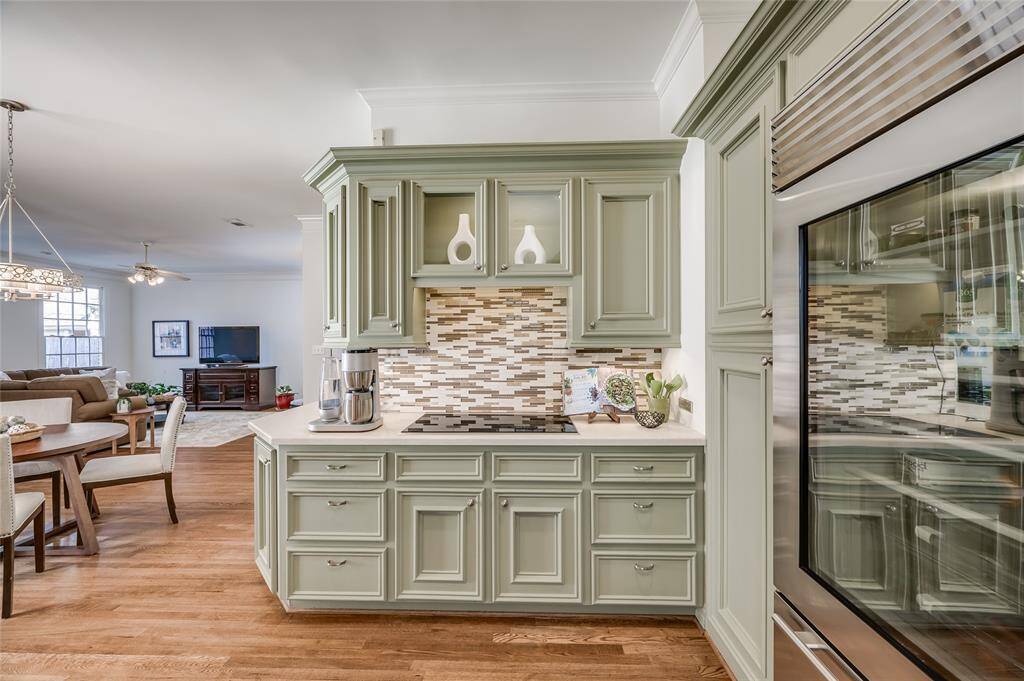 Take your culinary talents indoors accompanied by appliances from Sub Zero and Viking in this elegant open concept kitchen.