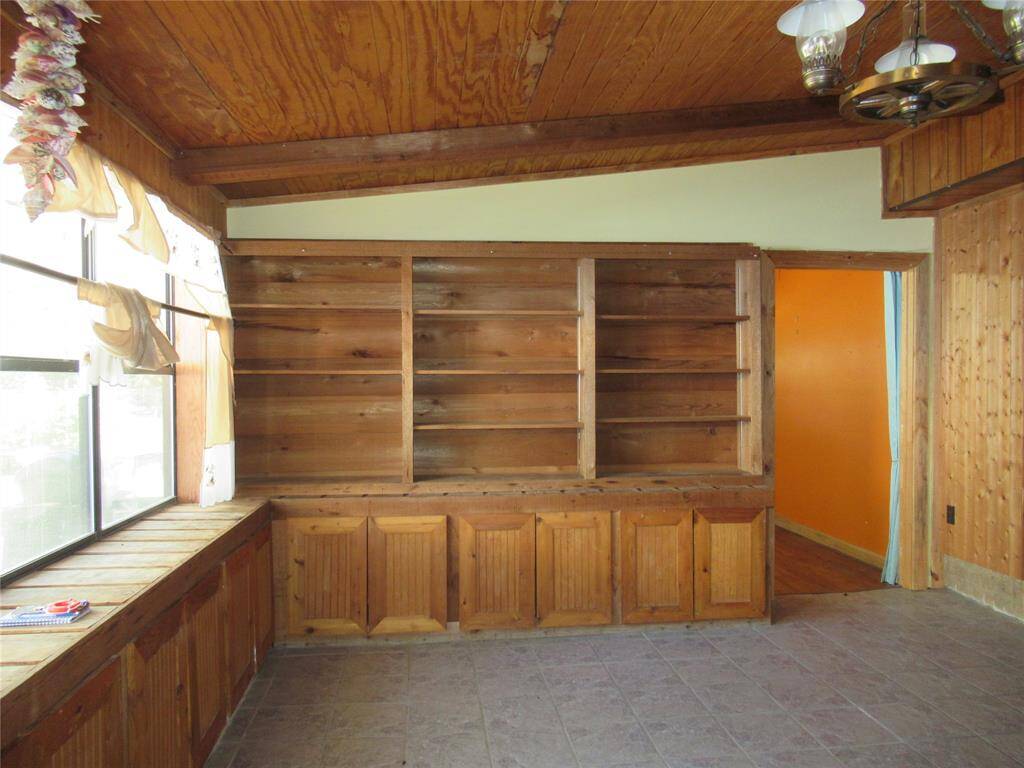 Showing book cases and windows that look to the view out back.